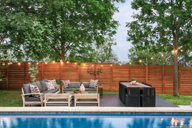 view of swimming pool with pool water feature, an outdoor living space, an in ground hot tub, and a yard