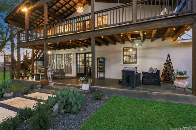 patio terrace at dusk featuring an outdoor hangout area