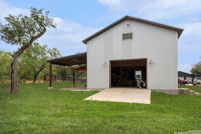 back of house featuring an outbuilding and a yard