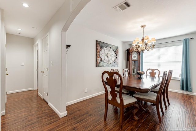 dining room with a notable chandelier and dark hardwood / wood-style floors