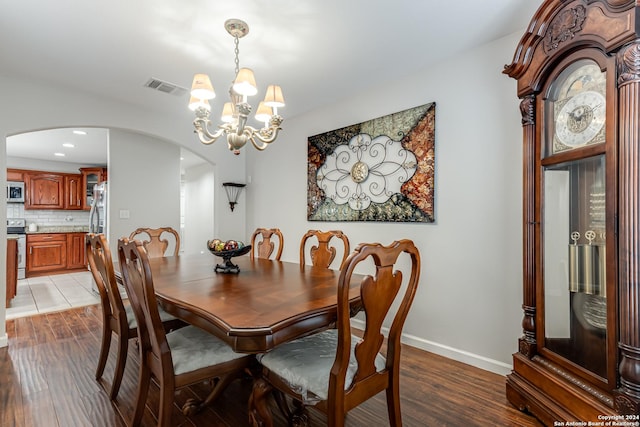 dining space with a chandelier and light wood-type flooring