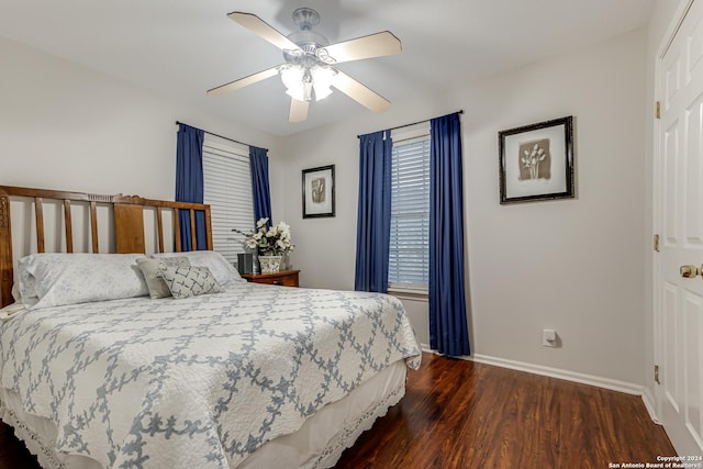 bedroom with dark hardwood / wood-style floors and ceiling fan