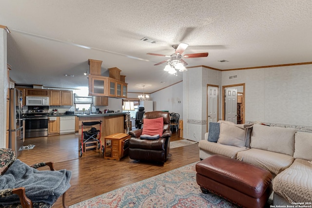 living room with hardwood / wood-style floors, crown molding, ceiling fan with notable chandelier, and a textured ceiling