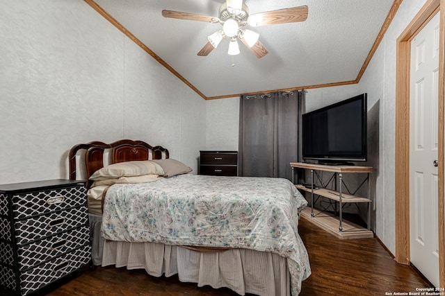 bedroom with dark wood-type flooring, lofted ceiling, a textured ceiling, ornamental molding, and ceiling fan