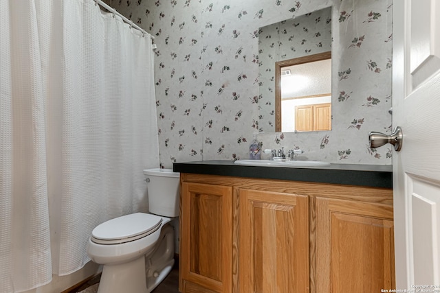 bathroom with a shower with curtain, vanity, and toilet