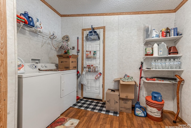 washroom featuring ornamental molding, hardwood / wood-style floors, a textured ceiling, and washer and clothes dryer