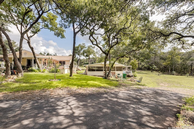 view of front of property featuring a front lawn and a sunroom