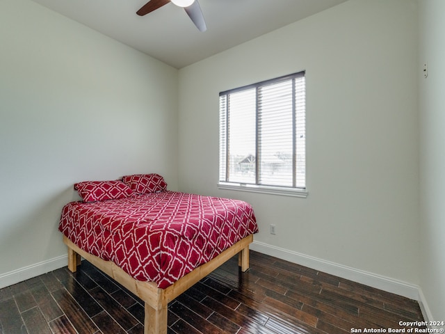 bedroom featuring wood-type flooring, multiple windows, and ceiling fan