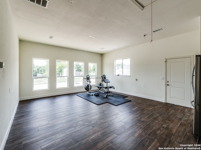 exercise area with dark hardwood / wood-style flooring