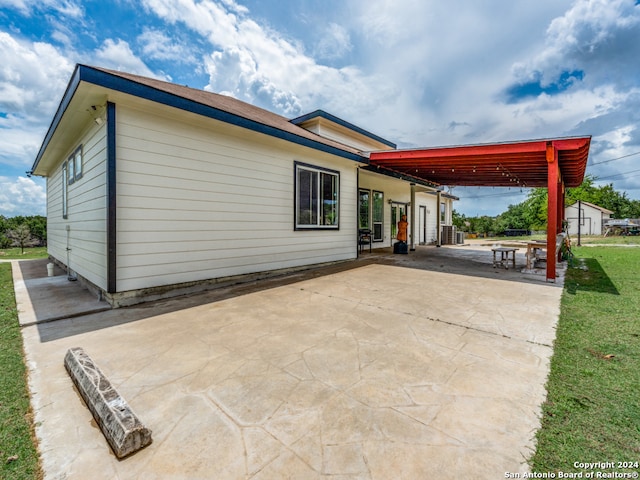 rear view of house featuring a yard