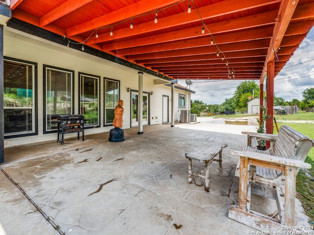 view of patio featuring central air condition unit and a storage unit