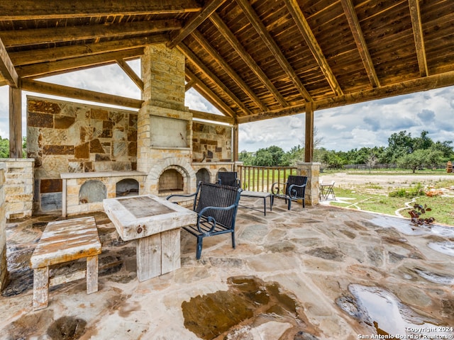 view of patio with an outdoor stone fireplace