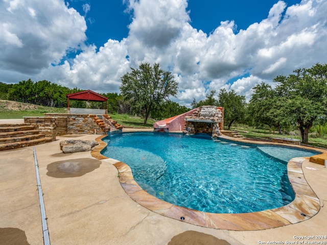 view of swimming pool featuring a patio area and pool water feature