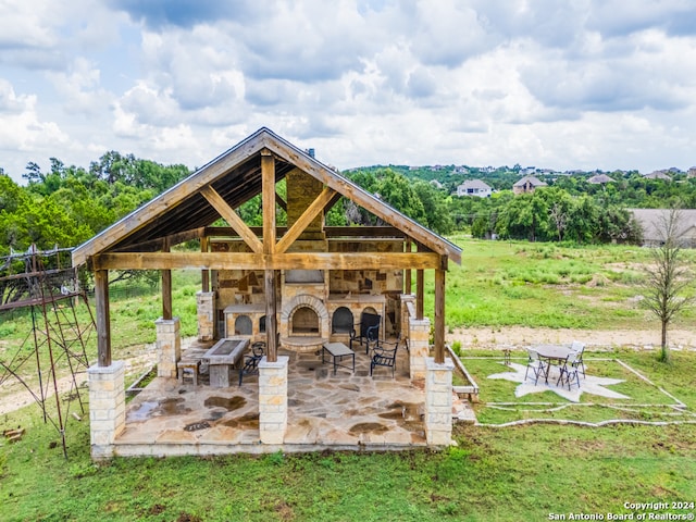 exterior space with an outdoor bar, a patio area, and a gazebo