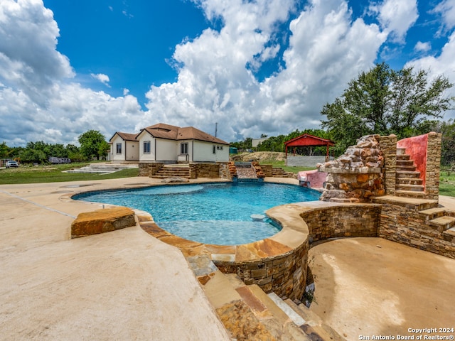 view of pool with pool water feature and a gazebo