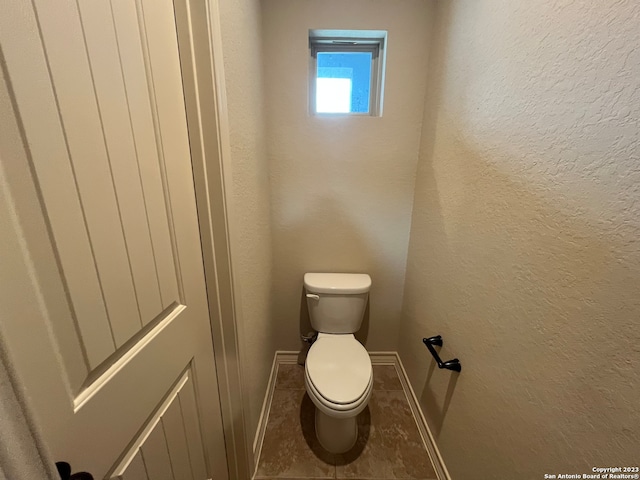 bathroom with tile patterned flooring and toilet