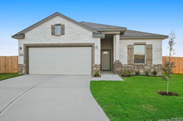 view of front of property with a garage and a front yard