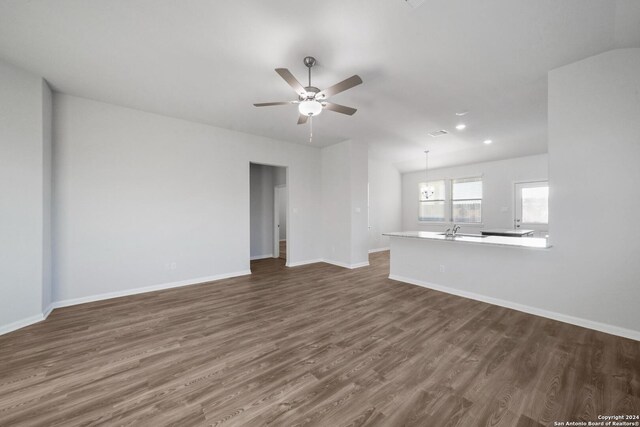 unfurnished living room with sink, dark hardwood / wood-style flooring, and ceiling fan