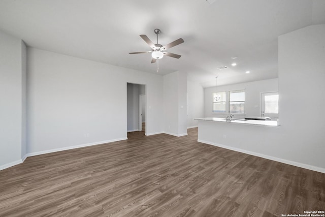 unfurnished living room featuring sink, dark wood-type flooring, and ceiling fan