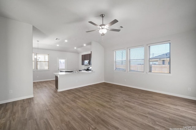 unfurnished living room with ceiling fan, lofted ceiling, dark hardwood / wood-style flooring, and sink