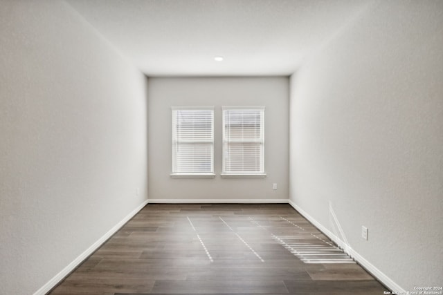 spare room with dark wood-type flooring