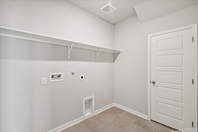 washroom with gas dryer hookup, washer hookup, light tile patterned floors, and electric dryer hookup