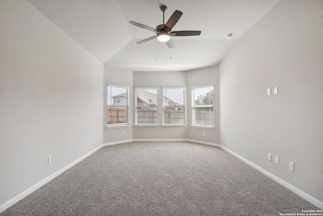 empty room featuring vaulted ceiling, ceiling fan, and carpet flooring