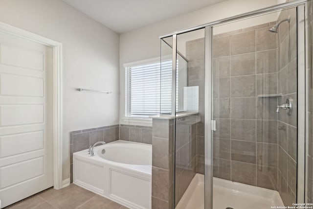 bathroom with tile patterned flooring and independent shower and bath