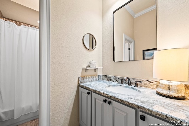 bathroom with crown molding and vanity