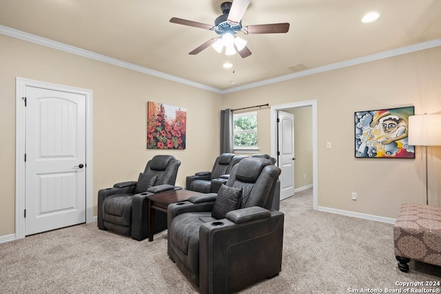 carpeted home theater featuring ornamental molding and ceiling fan