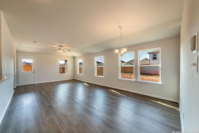 unfurnished living room featuring ceiling fan with notable chandelier and dark wood-type flooring