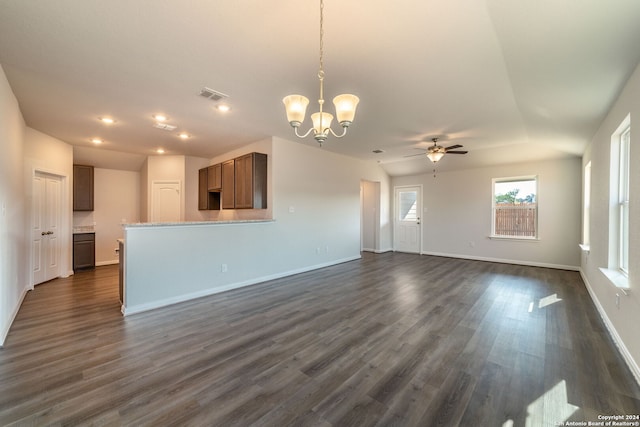 unfurnished living room with dark wood-type flooring and ceiling fan with notable chandelier