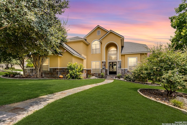 view of front of home with a yard