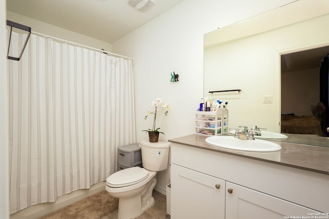 bathroom with wood-type flooring, toilet, and vanity