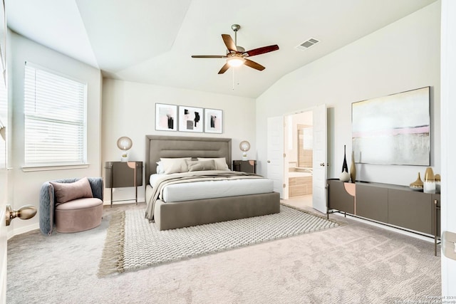 carpeted bedroom with ceiling fan, ensuite bath, and vaulted ceiling