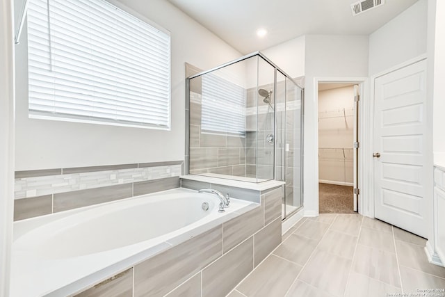 bathroom featuring tile patterned floors and independent shower and bath