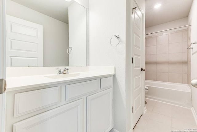 full bathroom featuring tile patterned floors, toilet, tiled shower / bath combo, and vanity