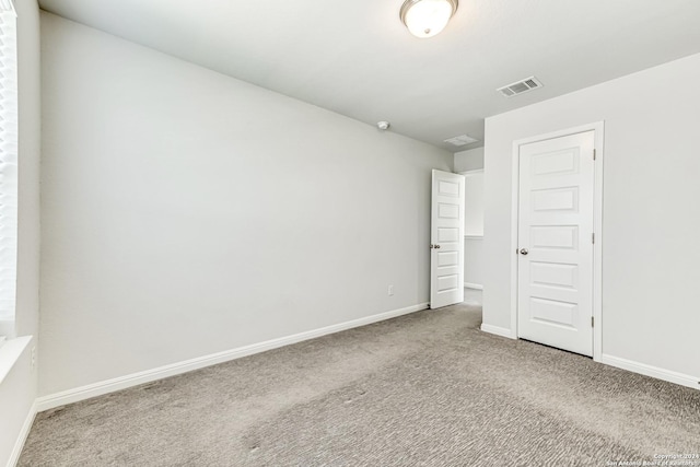 spare room featuring carpet and a textured ceiling