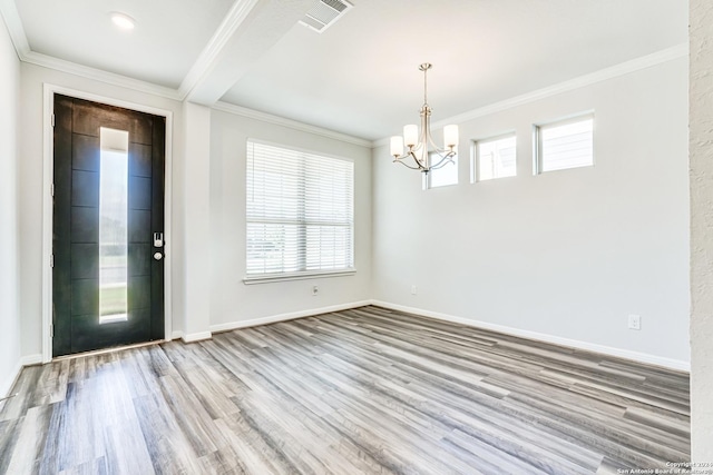 interior space with ornamental molding, a chandelier, and light hardwood / wood-style floors