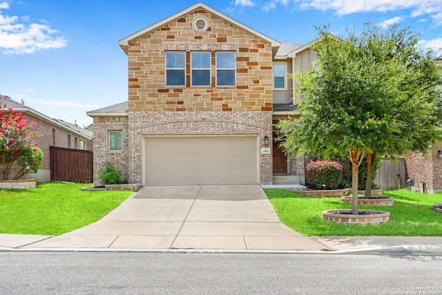 view of property featuring a front yard and a garage