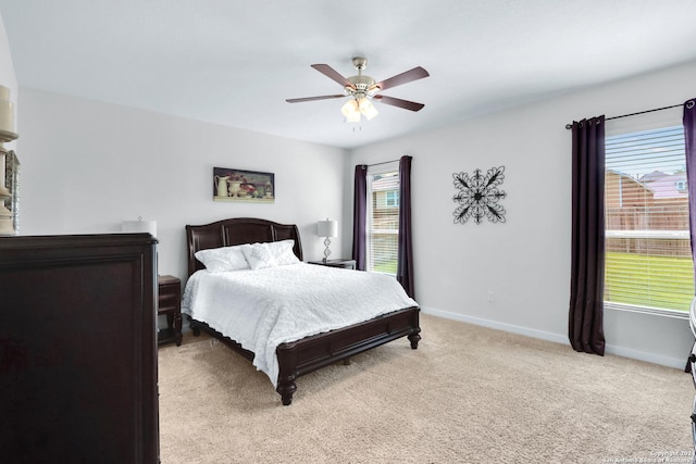 bedroom featuring ceiling fan and light carpet