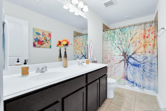 full bathroom featuring vanity, shower / bath combo, toilet, and tile patterned floors