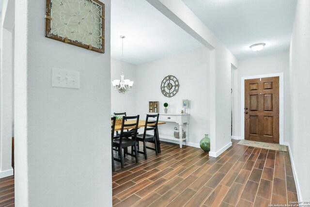 dining space featuring a notable chandelier and dark hardwood / wood-style flooring