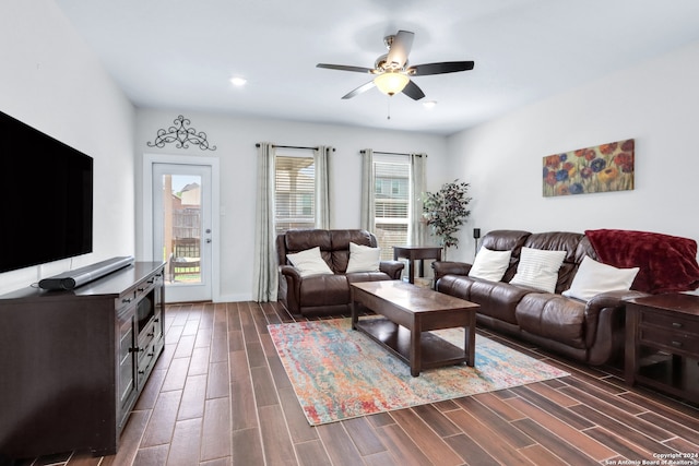 living room featuring ceiling fan and dark hardwood / wood-style flooring