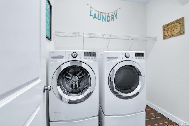 clothes washing area with washer and clothes dryer