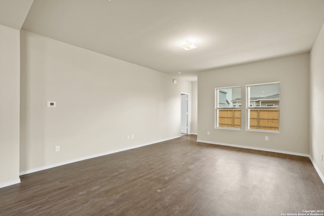 empty room featuring dark hardwood / wood-style flooring