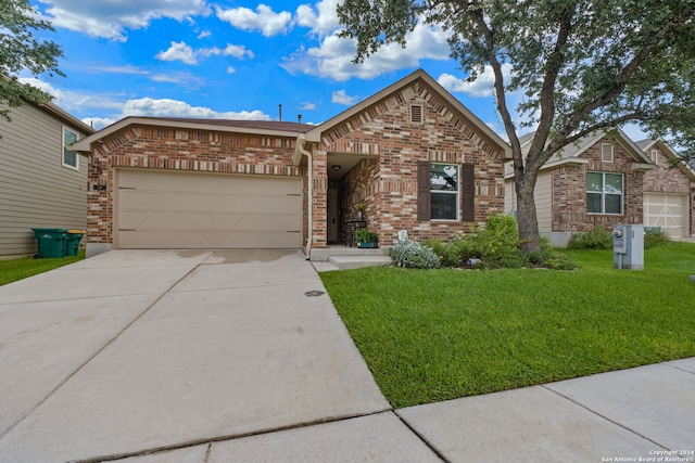 view of front facade with a garage and a front lawn