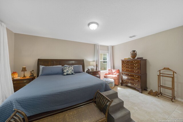 bedroom featuring light tile patterned floors