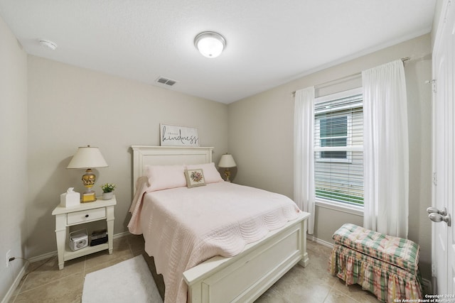 bedroom with light tile patterned floors