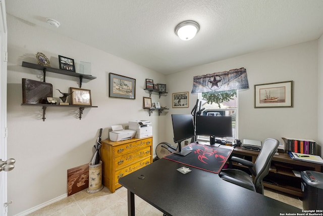 tiled office featuring a textured ceiling